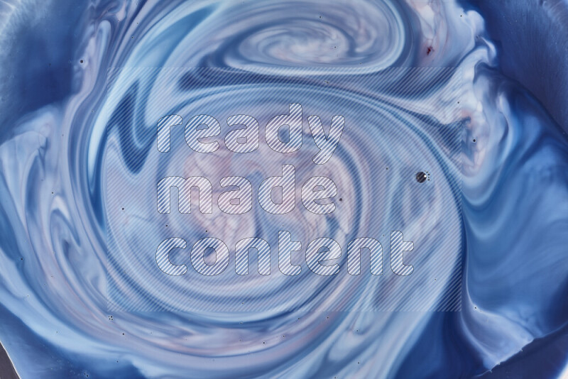 A close-up of abstract swirling patterns in blue, red and white