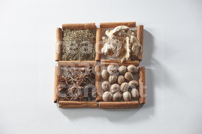 4 squares of cinnamon sticks full of star anise, ginger, cumin and nutmeg on white flooring