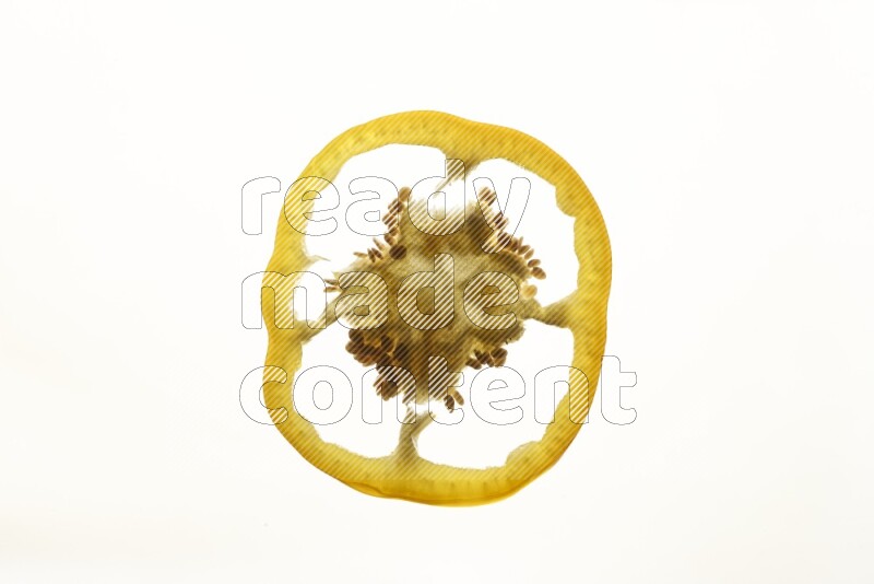 Yellow bell pepper slices on illuminated white background