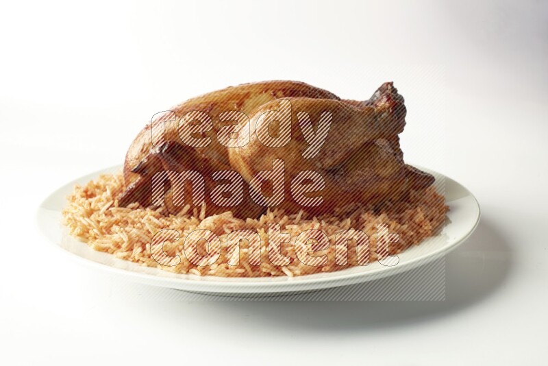 red basmati Rice with  whole roasted chicken on a white rounded plate  direct  on white background