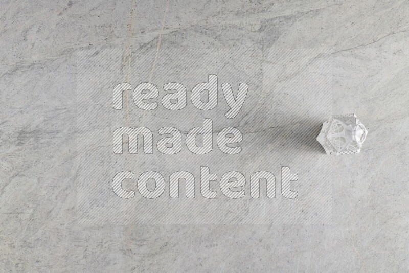 A candle lantern on grey marble background