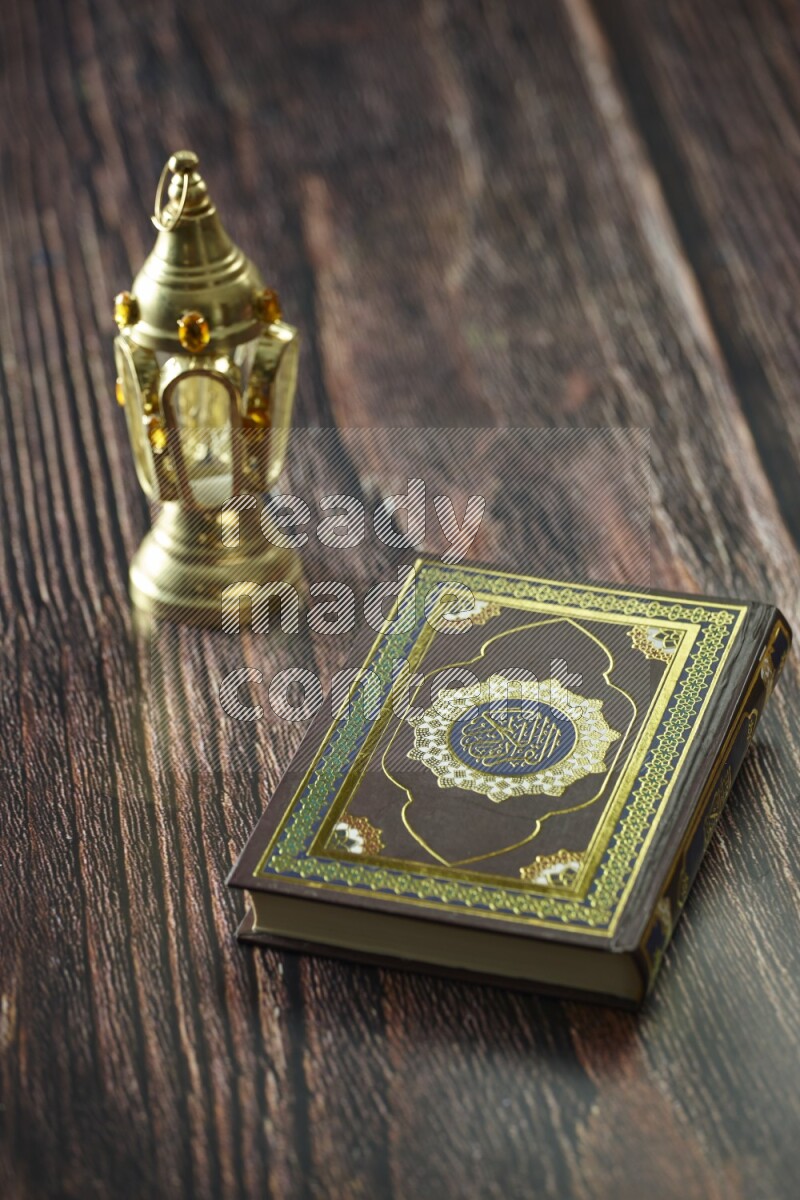 A golden lantern with different drinks, dates, nuts, prayer beads and quran on brown wooden background