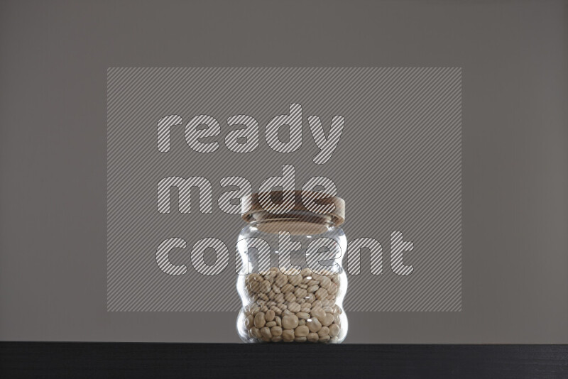 Lupin Beans in a glass jar on black background