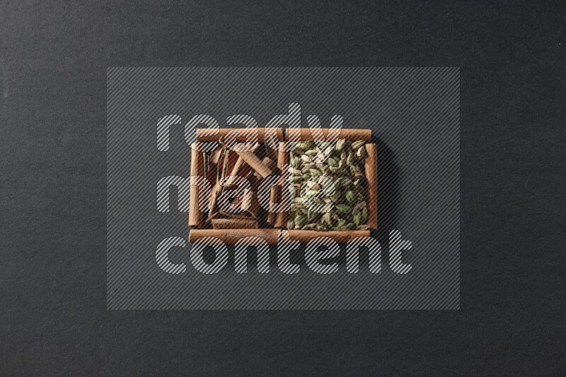 2 squares of cinnamon sticks full of cardamom and cinnamon on black flooring