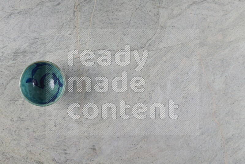 A multicolored pottery Bowl on grey marble background