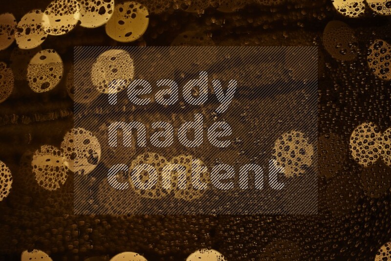 Bokeh light in yellow with water drops