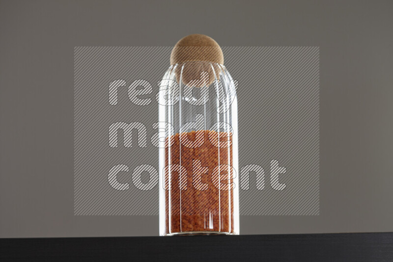 Lentils in a glass jar on black background