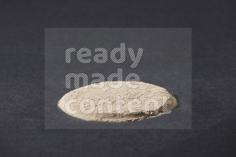 Garlic powder in a circle shape on a black flooring