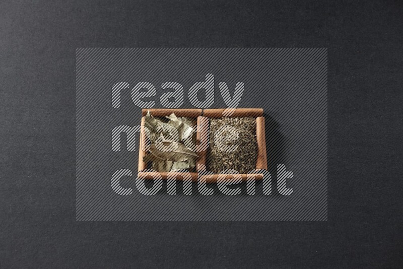 2 squares of cinnamon sticks full of cumin and bay laurel leaves on black flooring