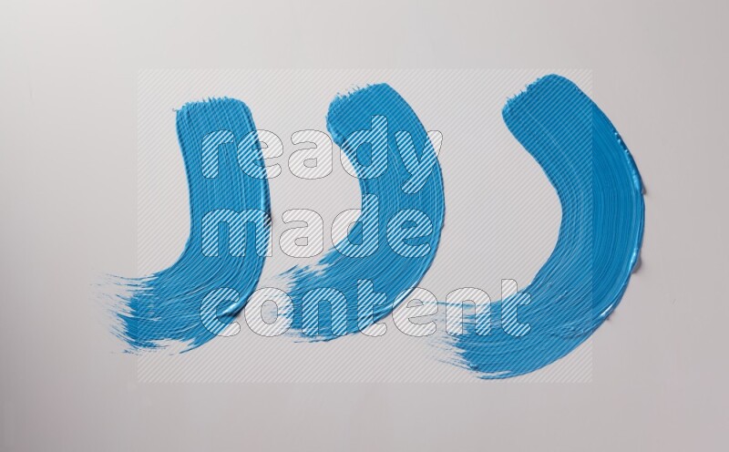 Multi blue curved brush strokes shaped into different shapes on a white background