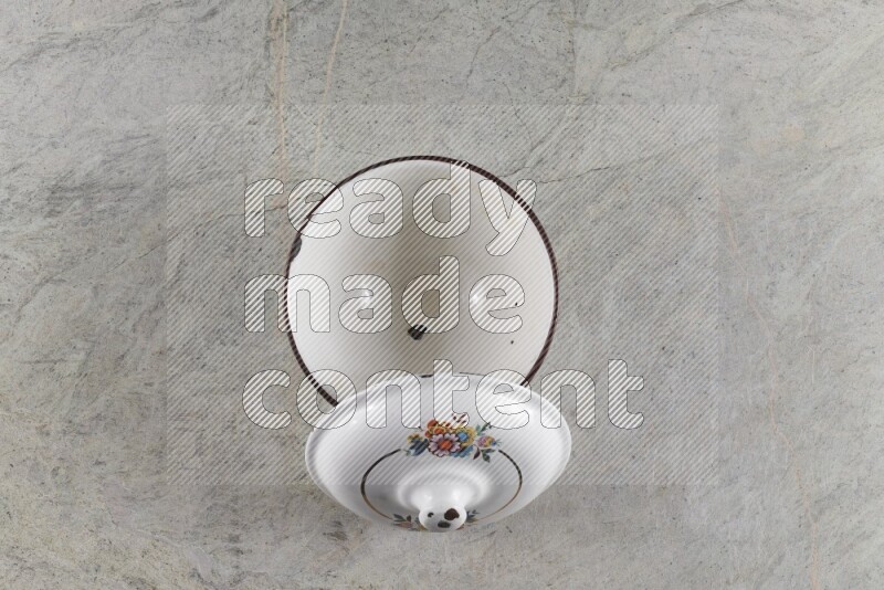 A vintage metal pot on grey marble background