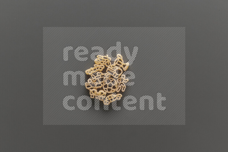 Shaped children pasta on grey background