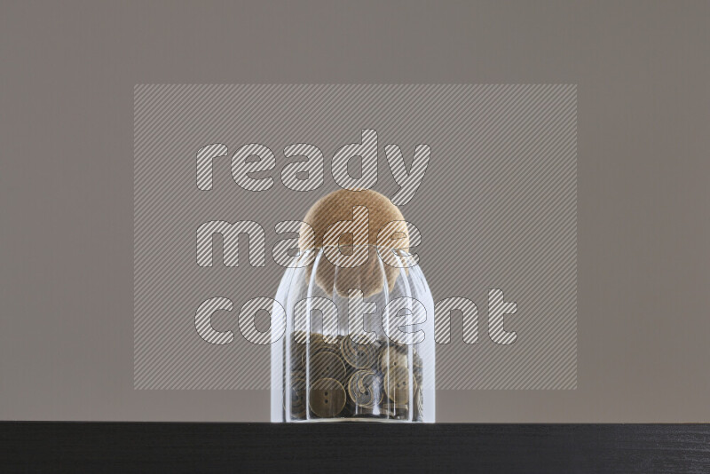 Buttons in a glass jar on black background