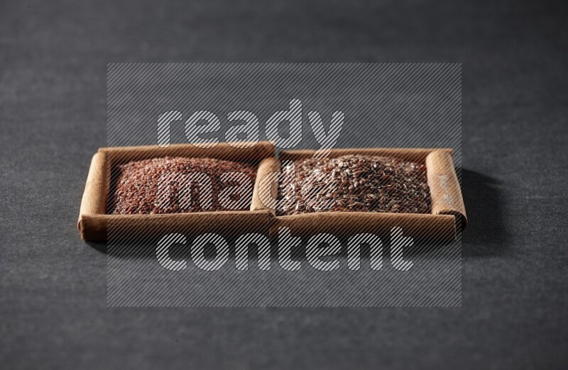 2 squares of cinnamon sticks full of garden cress and flaxseeds on black flooring