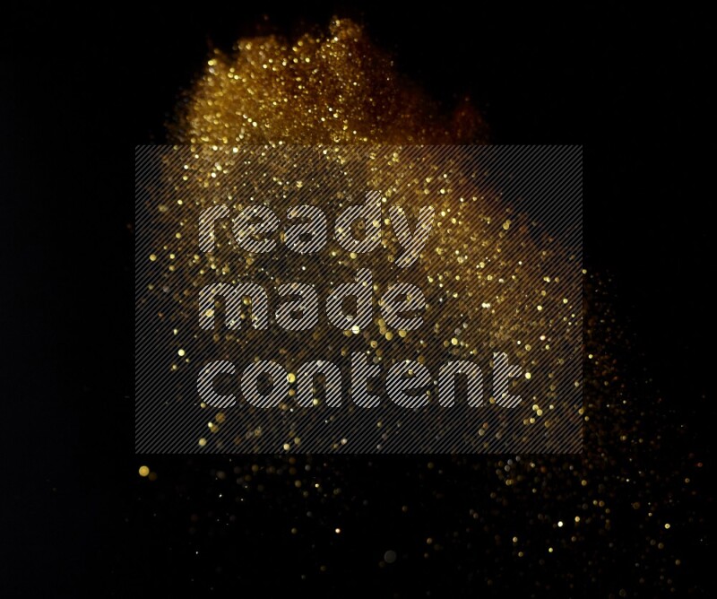 Gold glitter powder isolated on black background