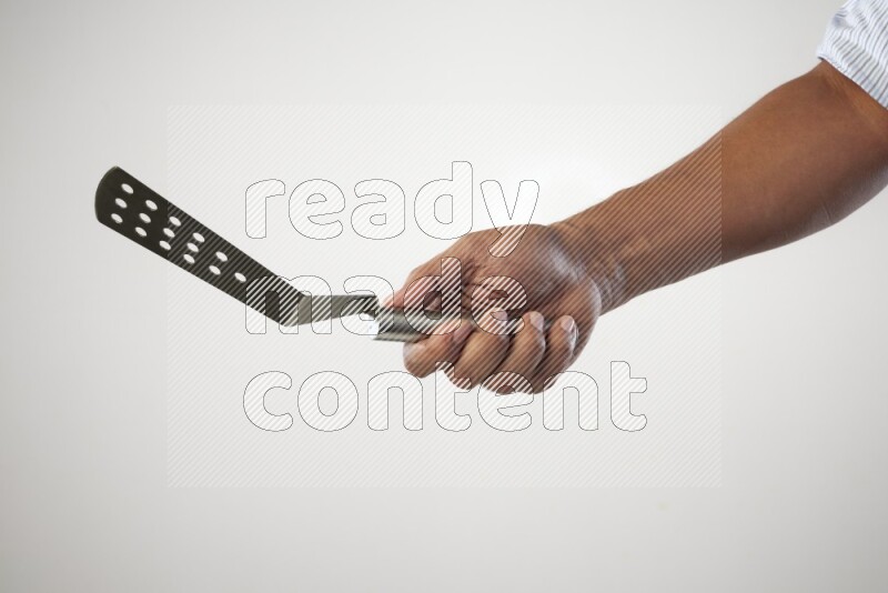 Male Hand Holding Burger Flipper on white background