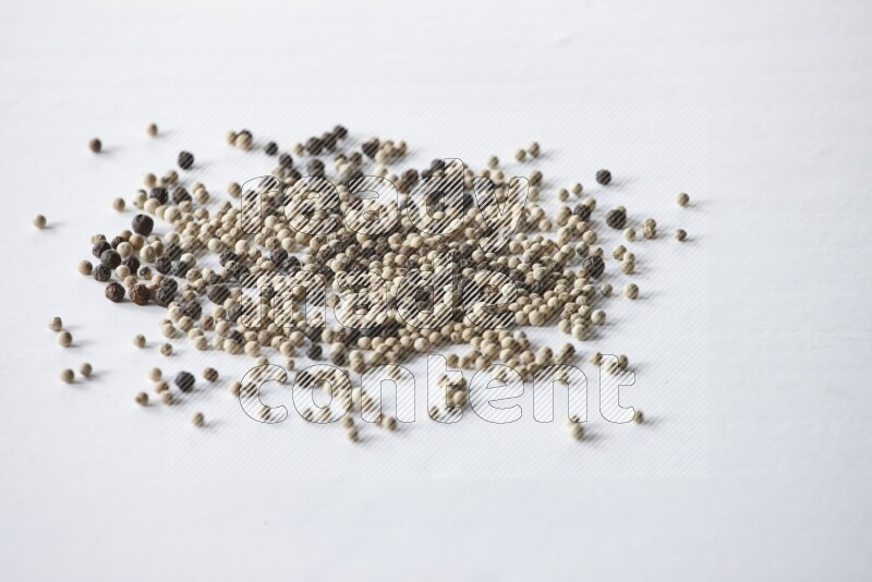 Mixed black and white pepper beads on a white flooring