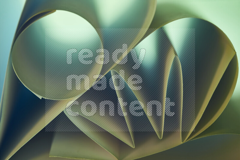 An artistic display of paper folds creating a harmonious blend of geometric shapes, highlighted by soft lighting in green and warm tones