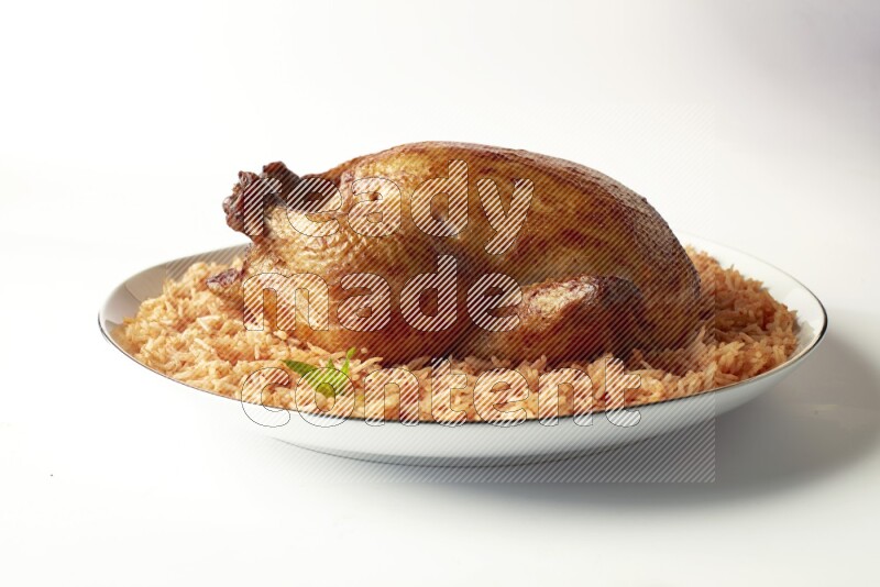 red basmati Rice with whole roasted chicken on a white plate with a silver rim direct on white background