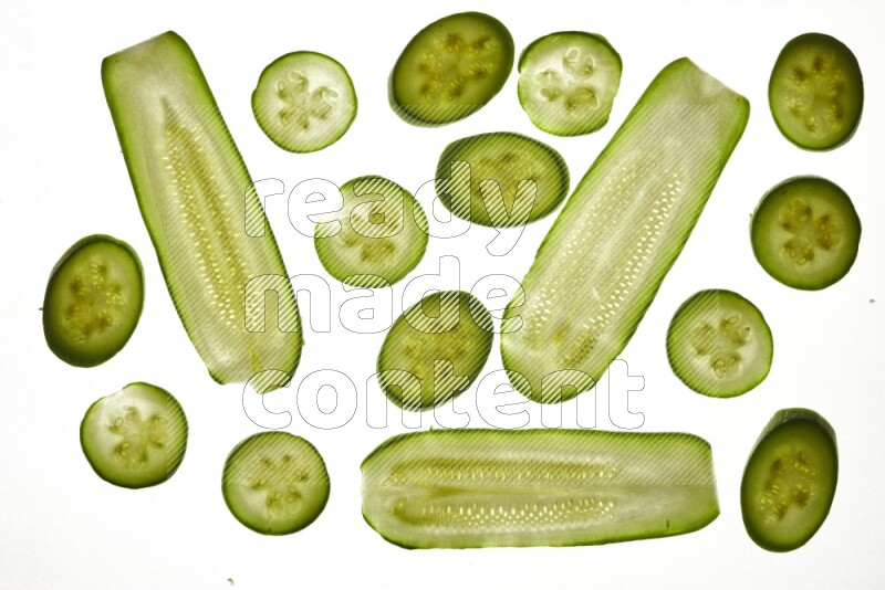 Zucchini slices on illuminated white background