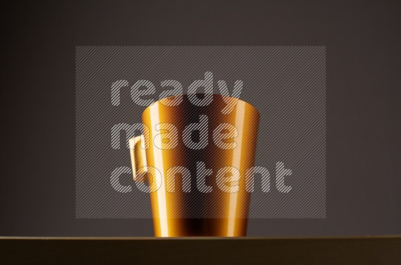 Low angle shot of a golden cup on grey background