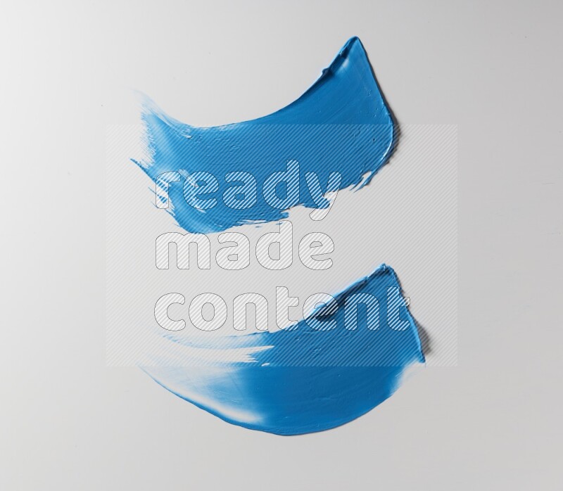 Blue curved painting knife strokes on white background