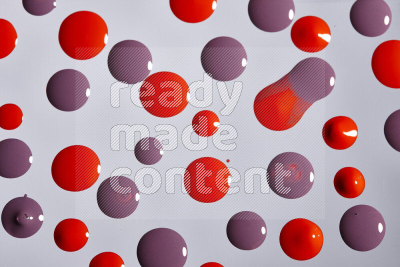 Close-ups of abstract purple and red paint droplets on the surface