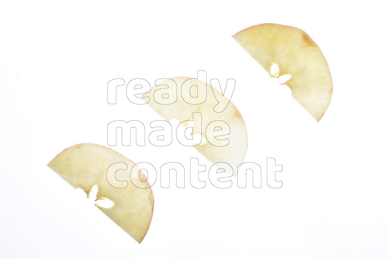 Apple slices on illuminated white background