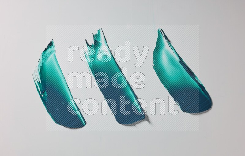Turquoise painting knife strokes on white background