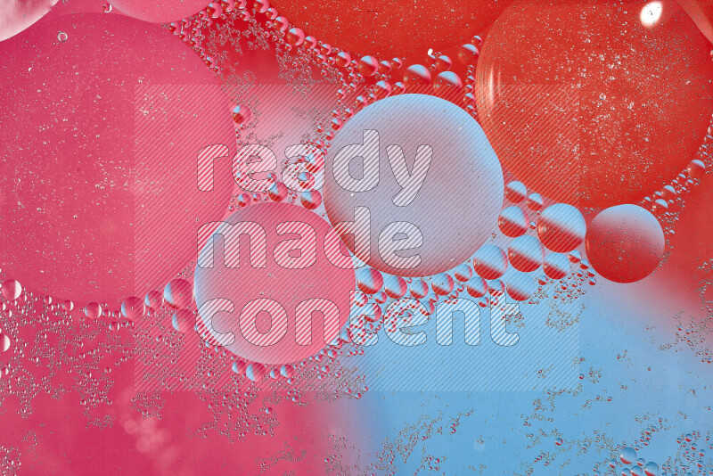 Close-ups of abstract oil bubbles on water surface in shades of blue, red and pink