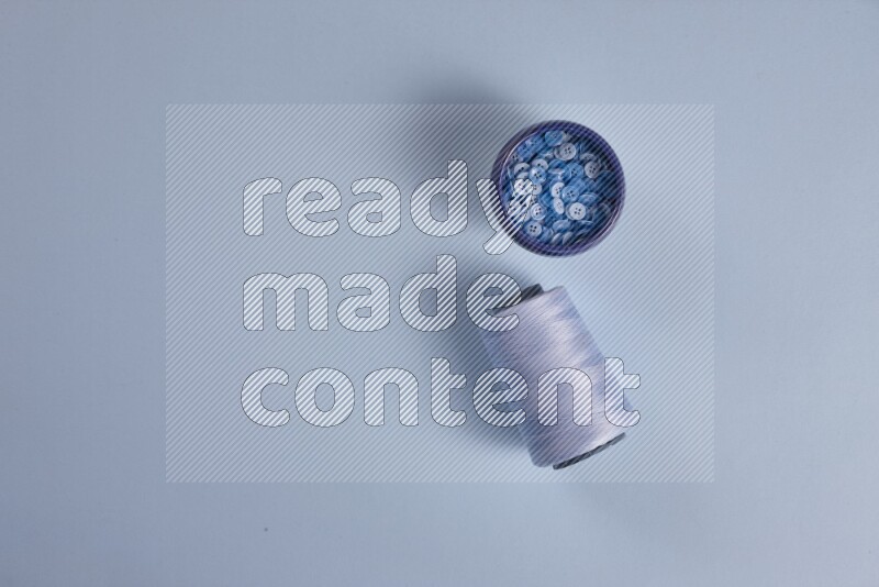 A blue collection of sewing and tailoring tools arranged on a blue background