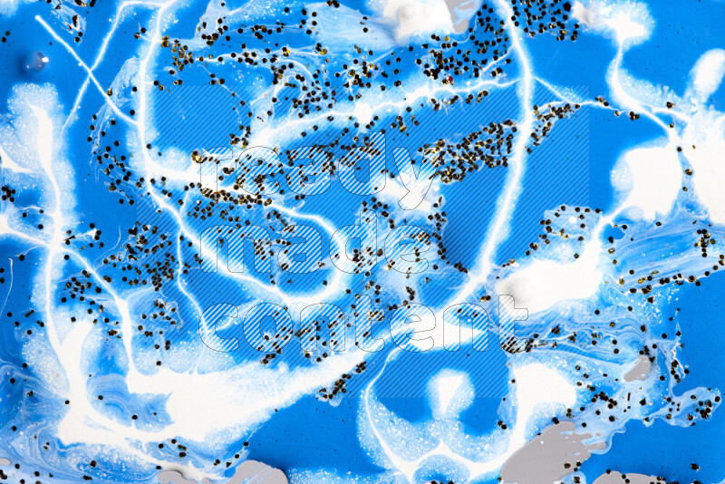 خلفية ملونة مع مزيج من ألوان الطلاء الأزرق والأبيض مع بريق ذهبي متناثر