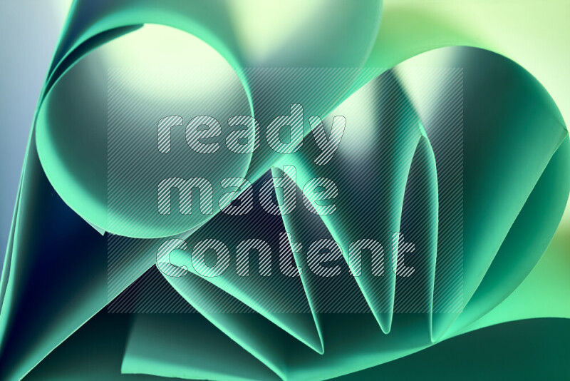 An artistic display of paper folds creating a harmonious blend of geometric shapes, highlighted by soft lighting in green tones