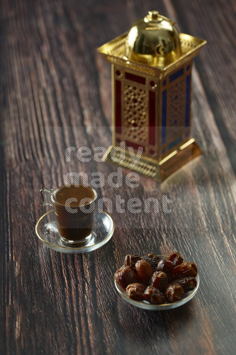 A golden lantern with different drinks, dates, nuts, prayer beads and quran on brown wooden background