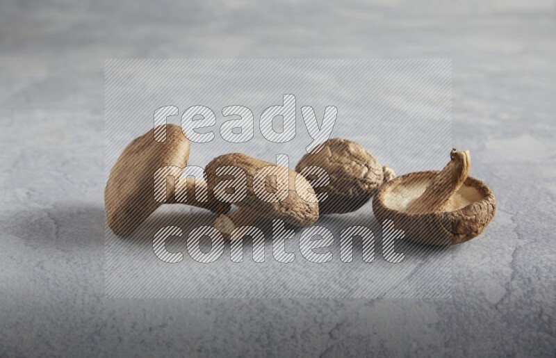 45 degre shiitake mushrooms on a textured light blue  background