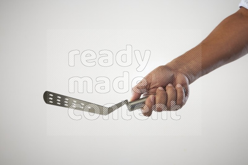 Male Hand Holding Burger Flipper on white background