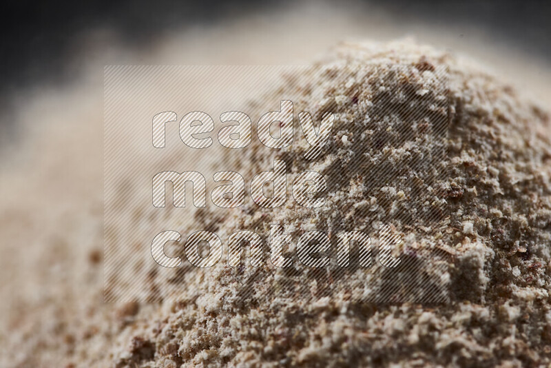 A bunch of onion powder on black background