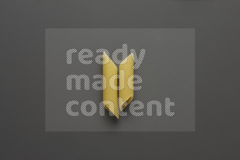 Penne pasta on grey background
