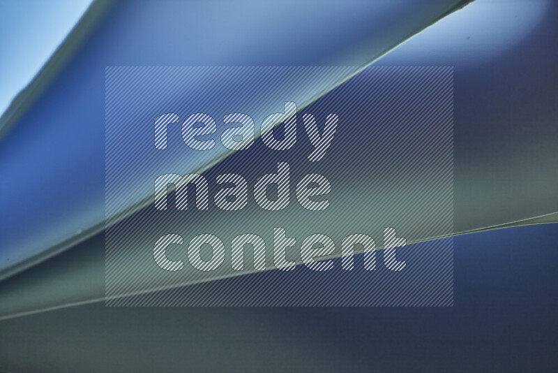 An abstract art piece displaying smooth curves in cold gradients created by colored light