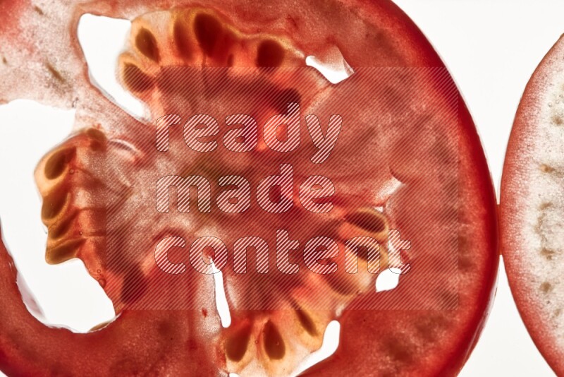 Tomatoes slices on illuminated white background
