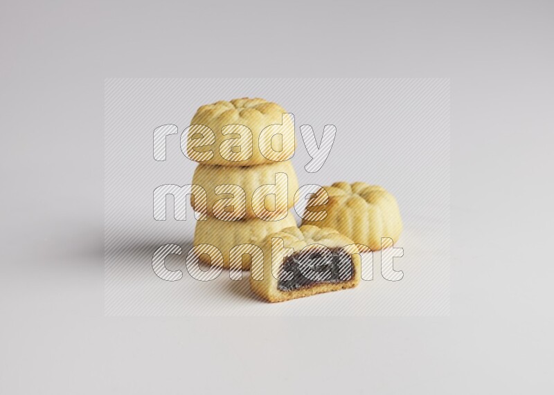 Five Pieces of Maamoul filled with date one of them is cut direct on white background