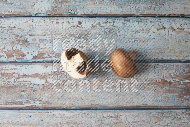 small fresh Cremini mushrooms topview on wooden blue background