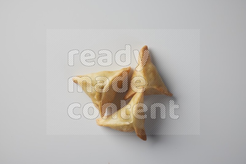 Three fried sambosa from a top angle on a white background