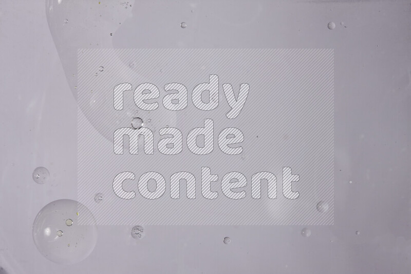 Abstract oil droplets in a water surface on white background