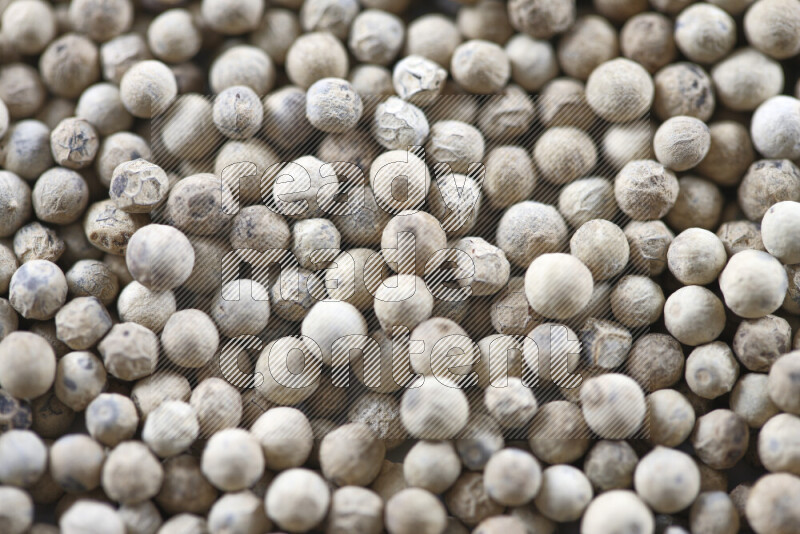 White pepper beads on white background