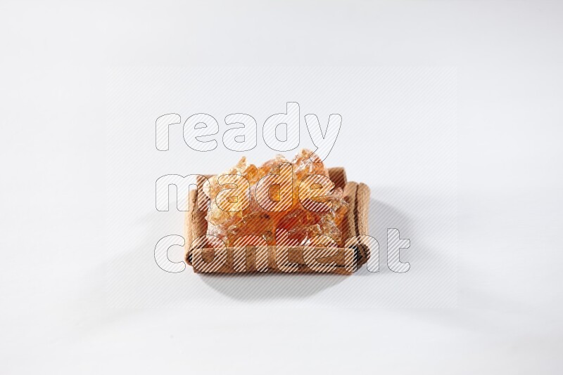 A single square of cinnamon sticks full of Arabic gum on white flooring