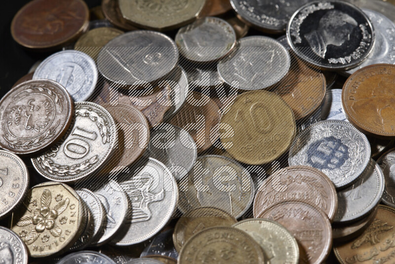 A close-ups of random old coins on black background