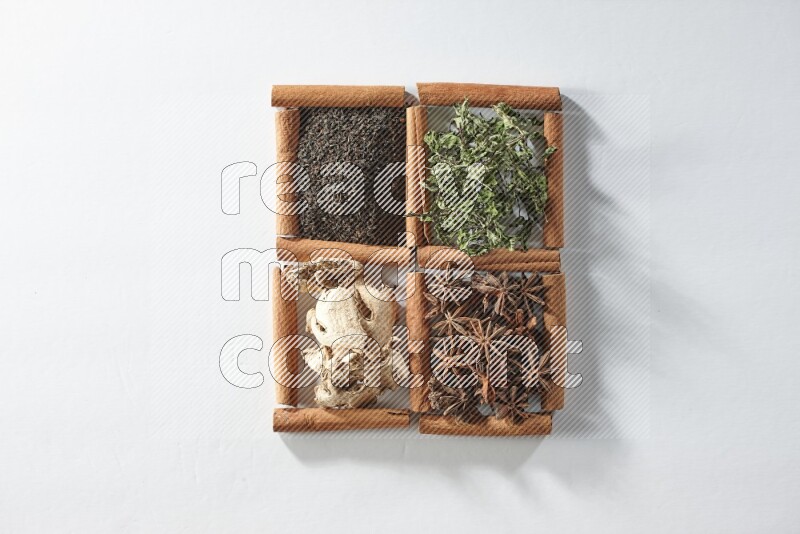 4 squares of cinnamon sticks full of tea, mint, star anise and ginger on white flooring