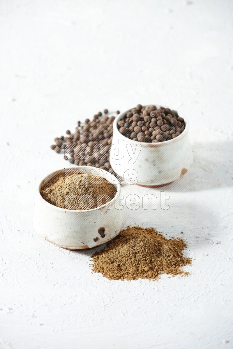 2 beige bowls, one full of powder and the other full of whole balls with balls and powder spreaded on a textured white flooring