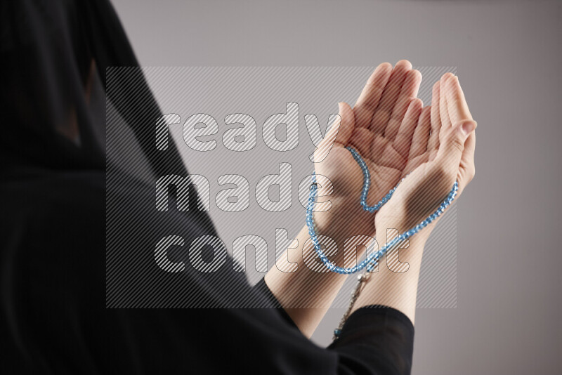 Woman hands holding praying beads (sebha) in different positions